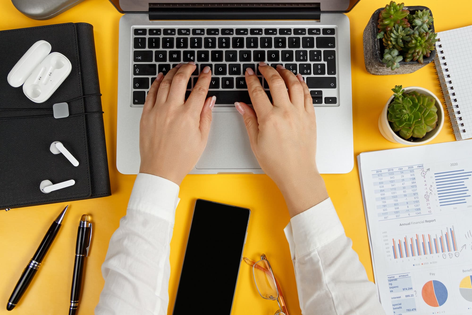 Business woman hands typing laptop top view