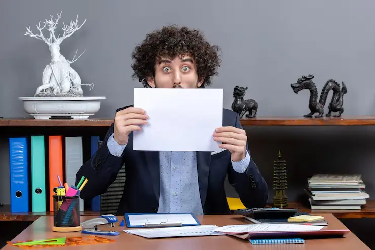 Front view shocked businessman holding up papers front his face office 140725 95681 (1)