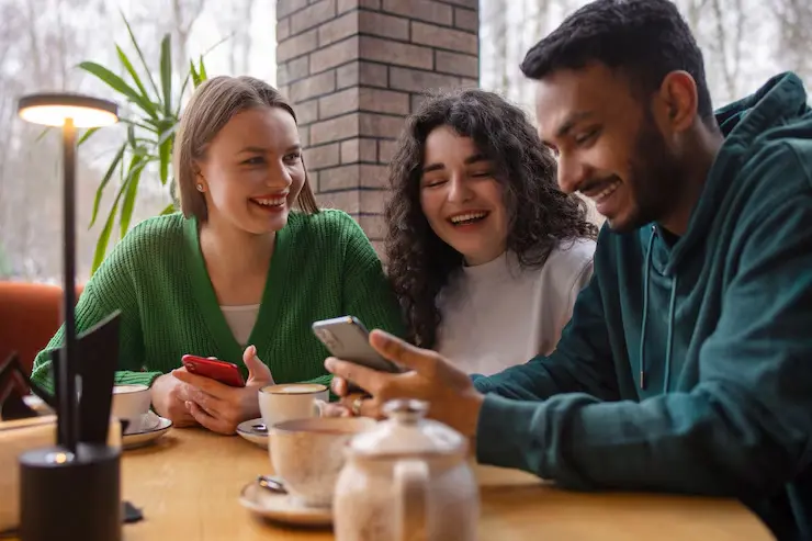 Medium shot smiley friends with smartphone 23 2150233613