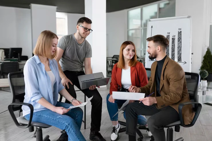 Four professionals discussing exclusive personal loan lead strategies with growth chart in modern office