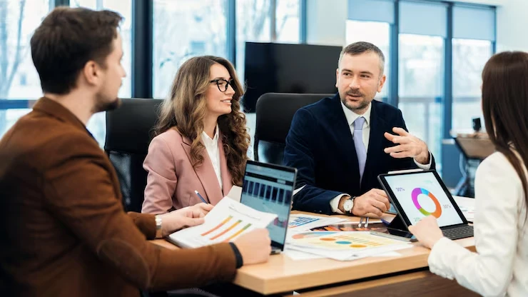 Executive team reviewing nurture campaign analytics and re-engagement program data in boardroom meeting