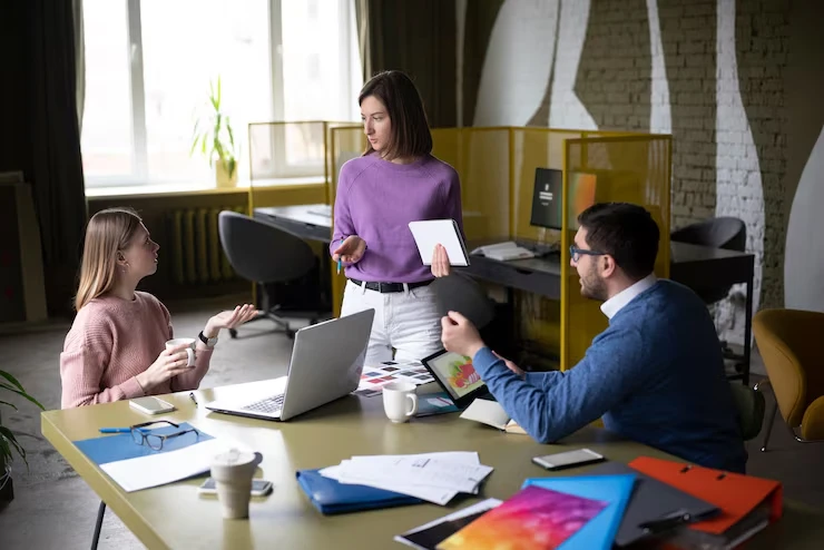 Three professionals discussing pre-qualified lead nurturing strategies in modern industrial office space