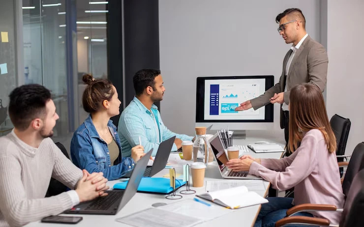Business team analyzing aged lead reactivation data and strategies in modern conference room presentation