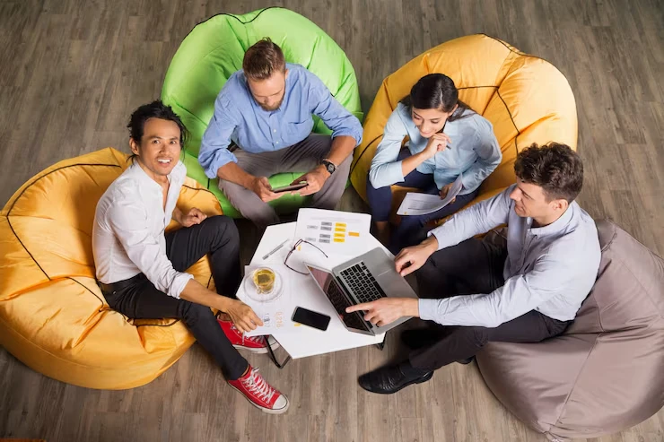Sales script creation team collaborating in creative workspace developing optimized calling scripts and frameworks