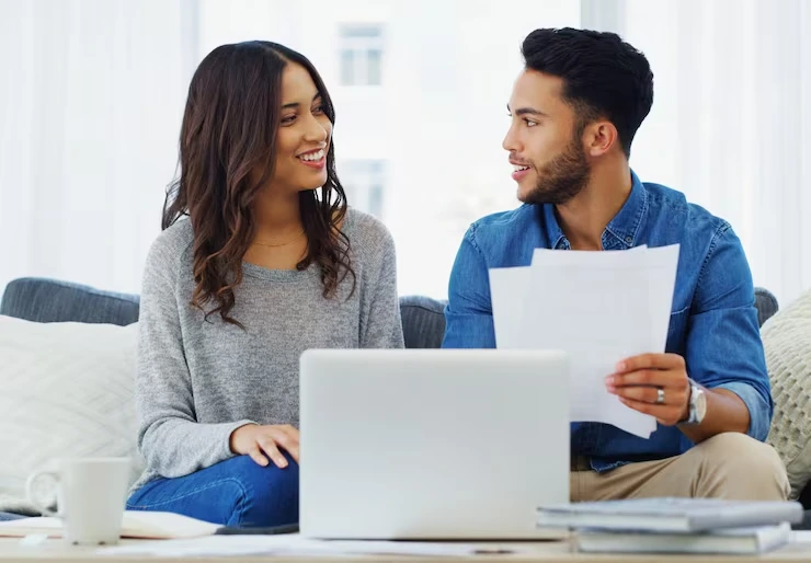 Campaign manager reviewing email performance report with client using laptop in casual office setting