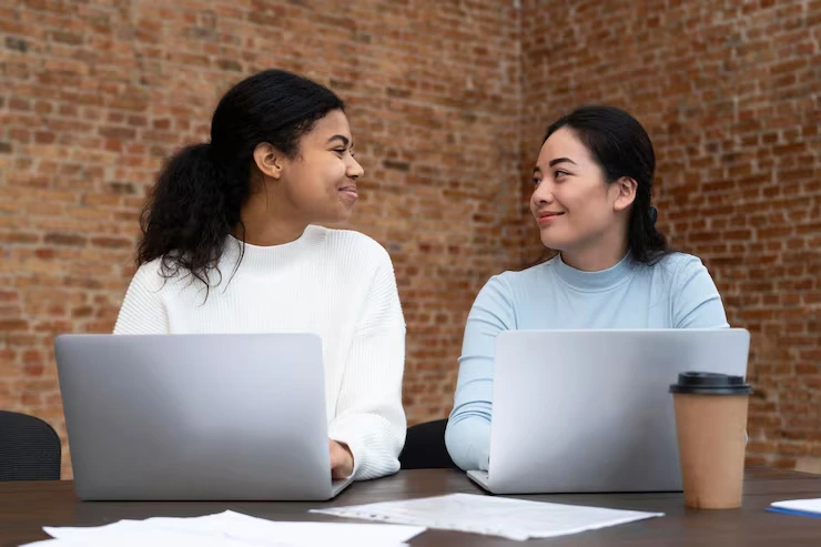 Marketing professionals review email campaign performance and audience segmentation data on laptops