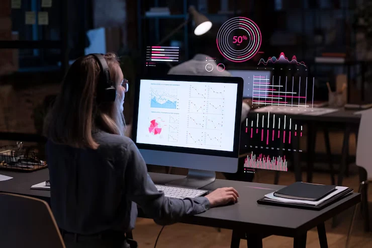 Woman analyzing podcast analytics dashboard showing audience demographics and engagement metrics on computer screen