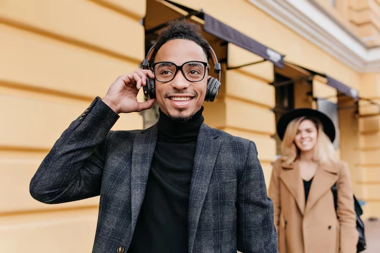Professional cold caller smiling during client call wearing headset outdoors