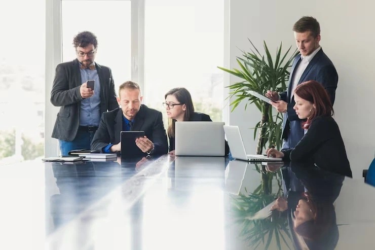 Team working on laptops and tablets in modern office