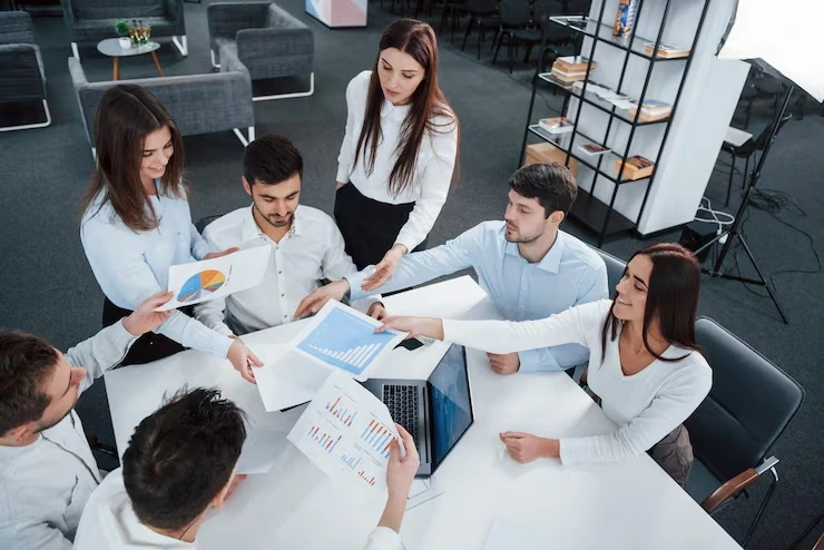 Team reviewing charts and reports in meeting